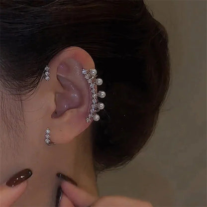 Close-up of woman's ear with pearl and crystal ear cuff and matching earrings